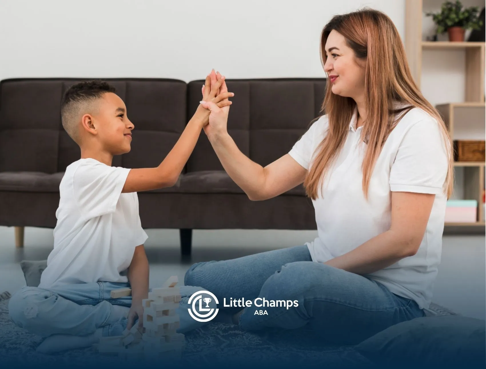 Autistic child and ABA therapist giving each other a high-five.