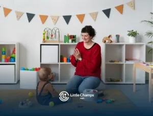 ABA therapist playing with a toddler on the floor.