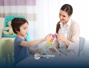 Autistic child interacting with ABA therapist while playing with a colorful abacus.