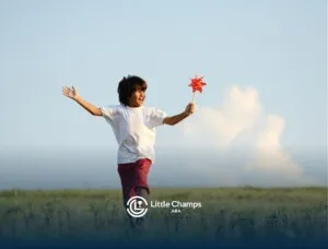 Autistic child running through a field holding a red pinwheel.