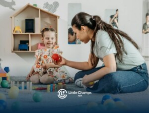 An ABA therapist playing with a smiling autistic girl using colorful toys indoors in Colorado.