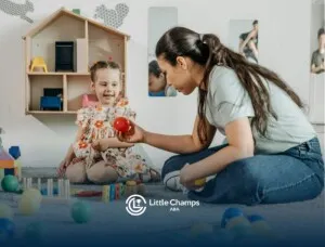 An ABA therapist playing with a smiling autistic girl using colorful toys indoors in Colorado.