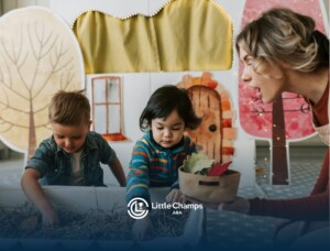 ABA therapist and two autistic kids playing with leaves in a sensory bin at a classroom in Colorado.