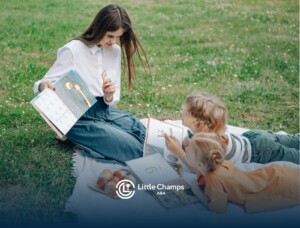 An ABA therapist and two autistic children reading books during an outdoor ABA therapy in Utah.