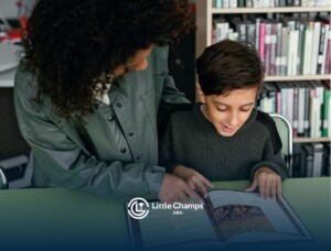 An ABA therapist helping young autistic boy read a book during ABA therapy at a library in Utah.