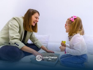 An ABA therapist giving sensory stimulation to a little girl