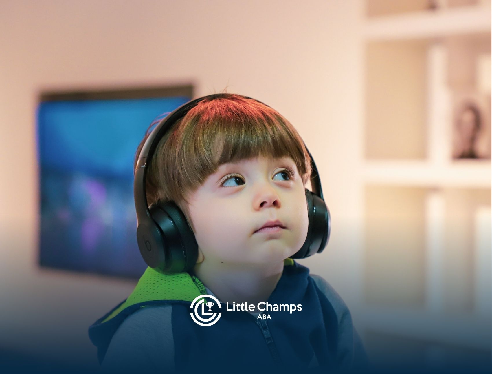 Young autistic child wearing noise-canceling headphones, looking up thoughtfully in Colorado.