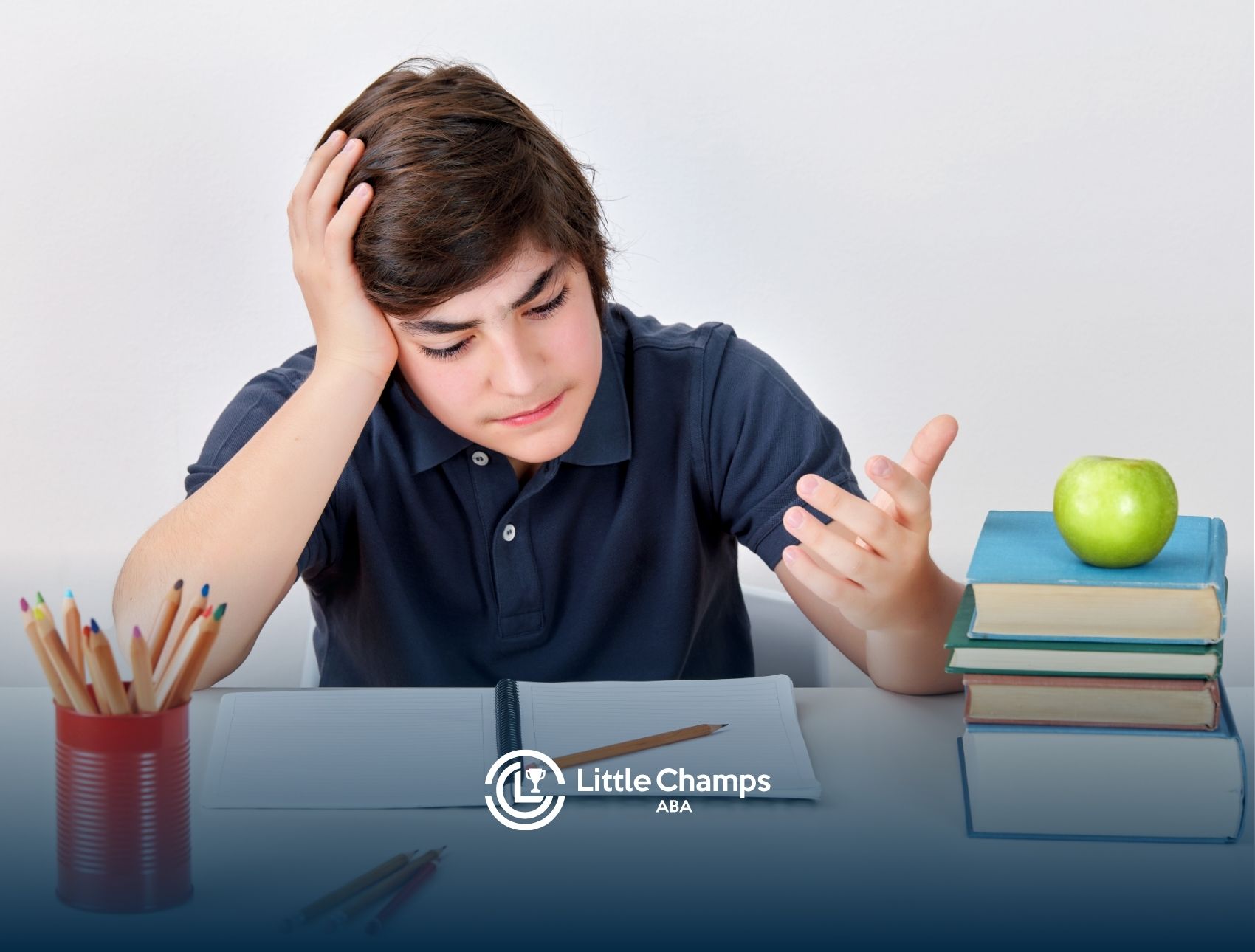A teenage boy studying, but looking confused.