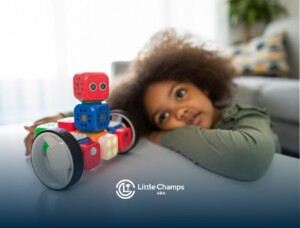 Autistic child resting head on table next to a robot toy during an in-home ABA therapy in Utah.