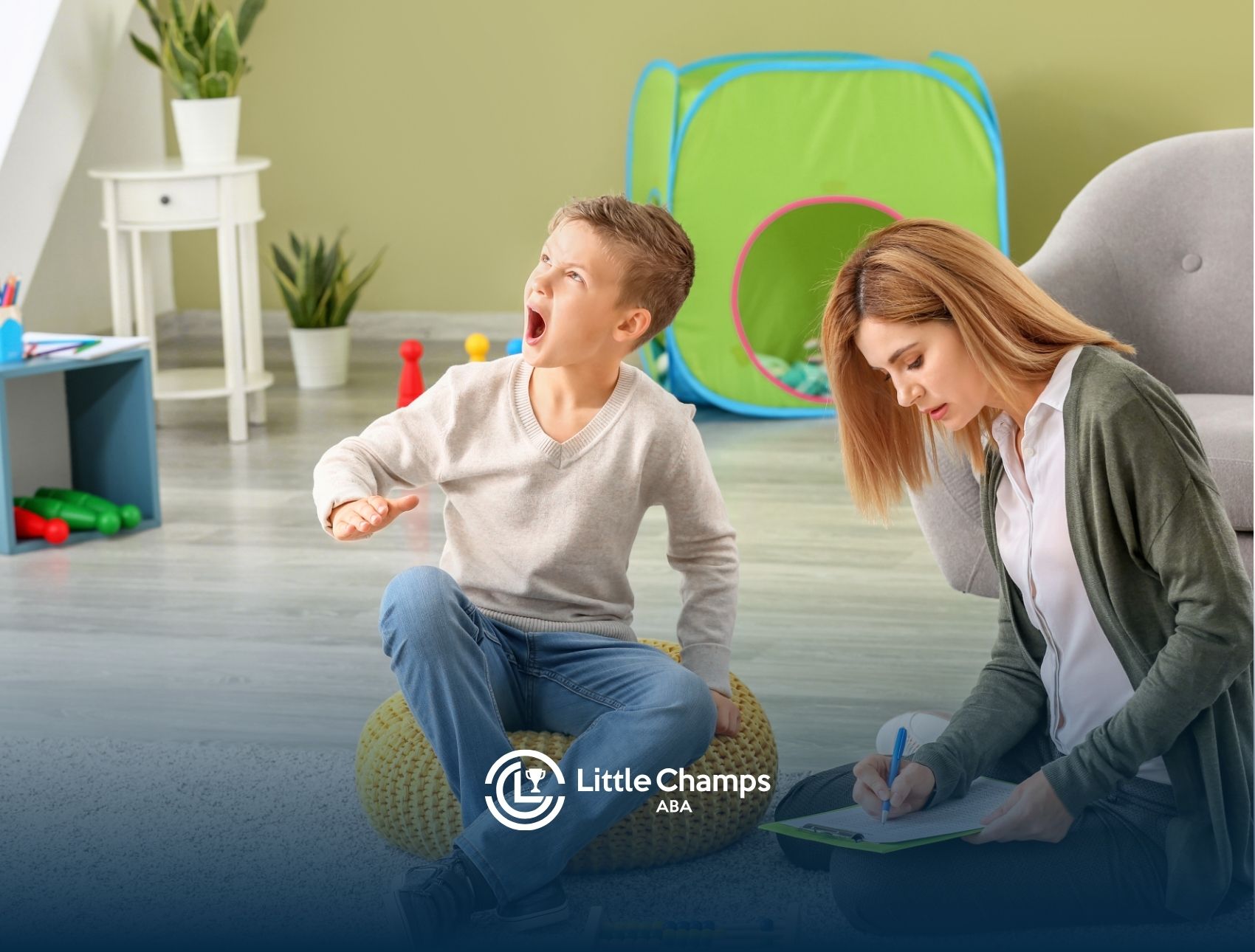 A little boy having a tantrum, with his ABA therapist making notes.
