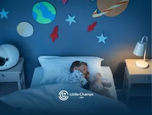 A child peacefully sleeping in a bed adorned with a colorful space-themed blanket and starry wall decor.