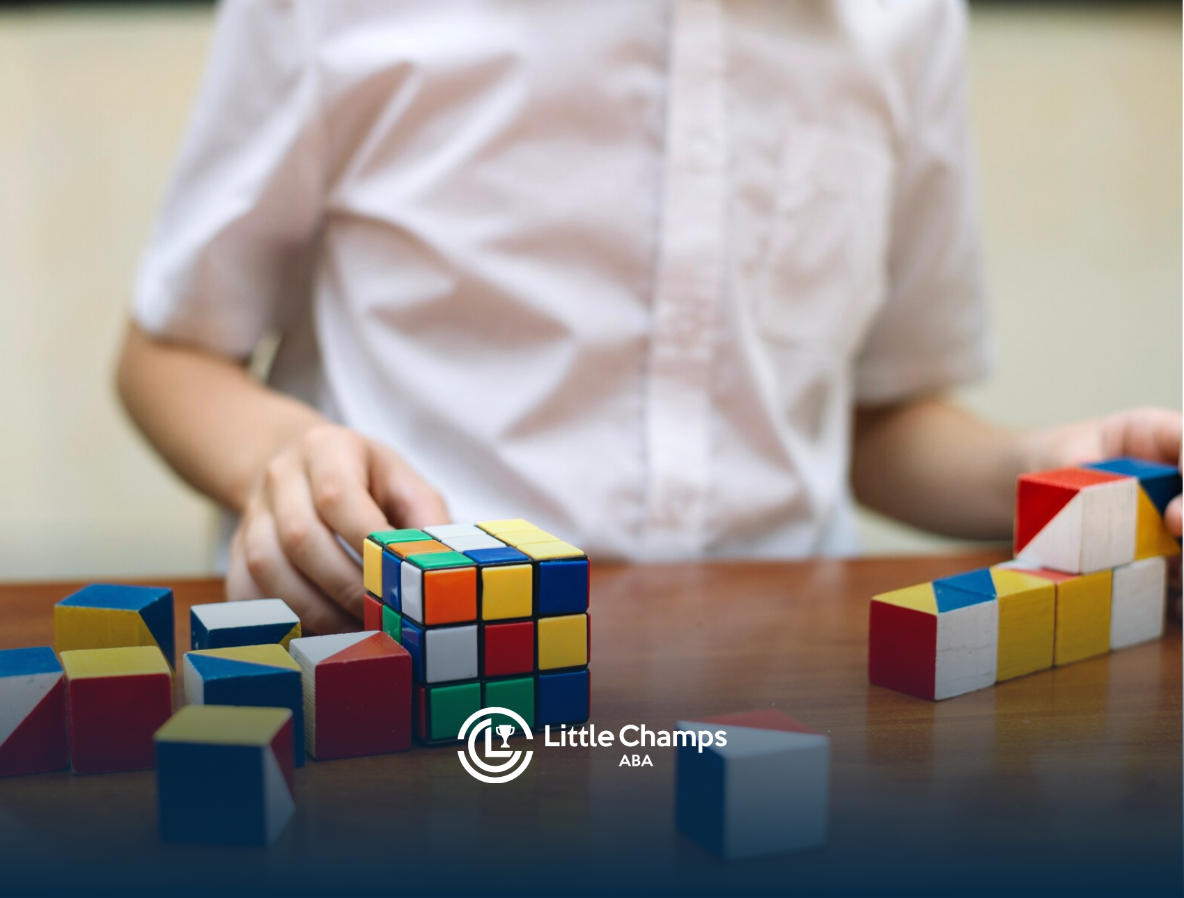 A child with autism is playing with Rubik's cubes on a table