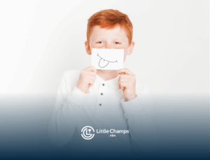 A boy with autism is covering his mouth with a paper