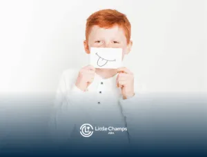 A boy with autism is covering his mouth with a paper