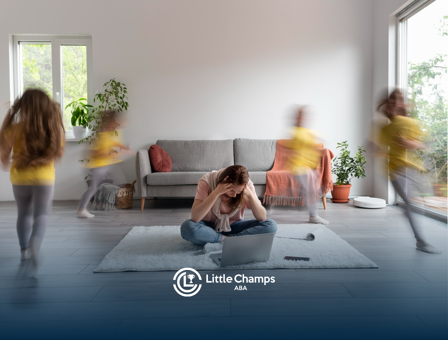 A mother is sitting in a living room holding her head while her daughter with autism is running around her