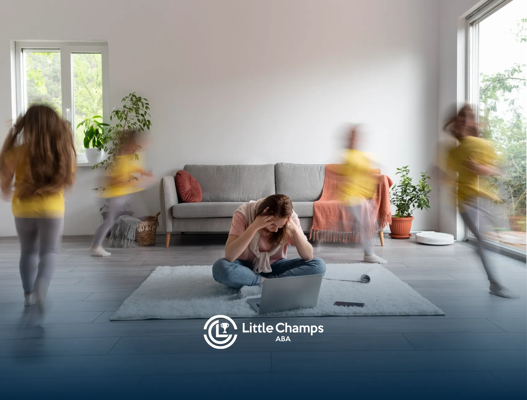 A mother is sitting in a living room holding her head while her daughter with autism is running around her