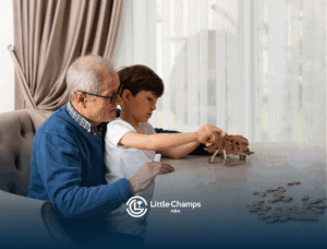 A child with autism and his grandfather are playing together on a table