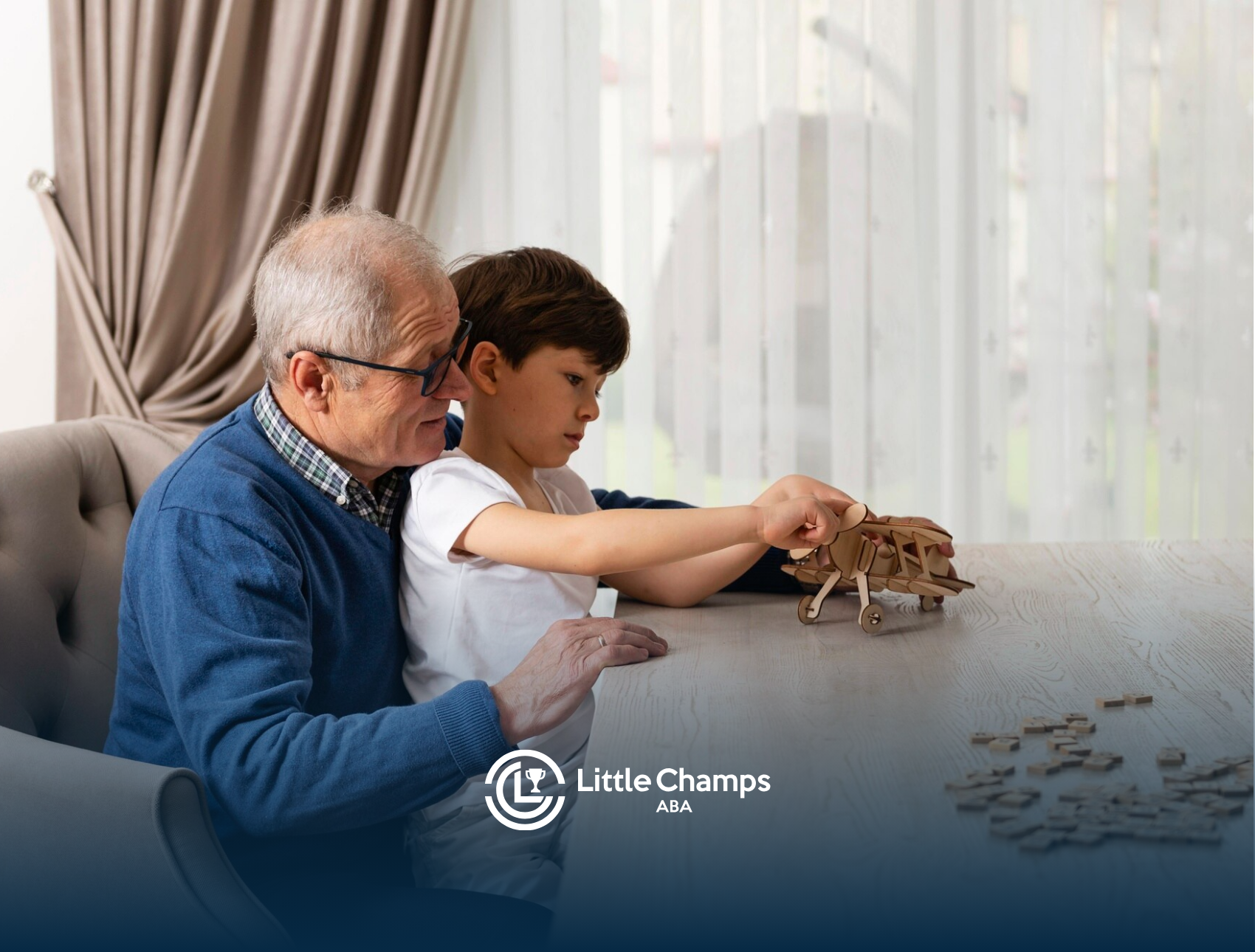 A child with autism and his grandfather are playing together on a table