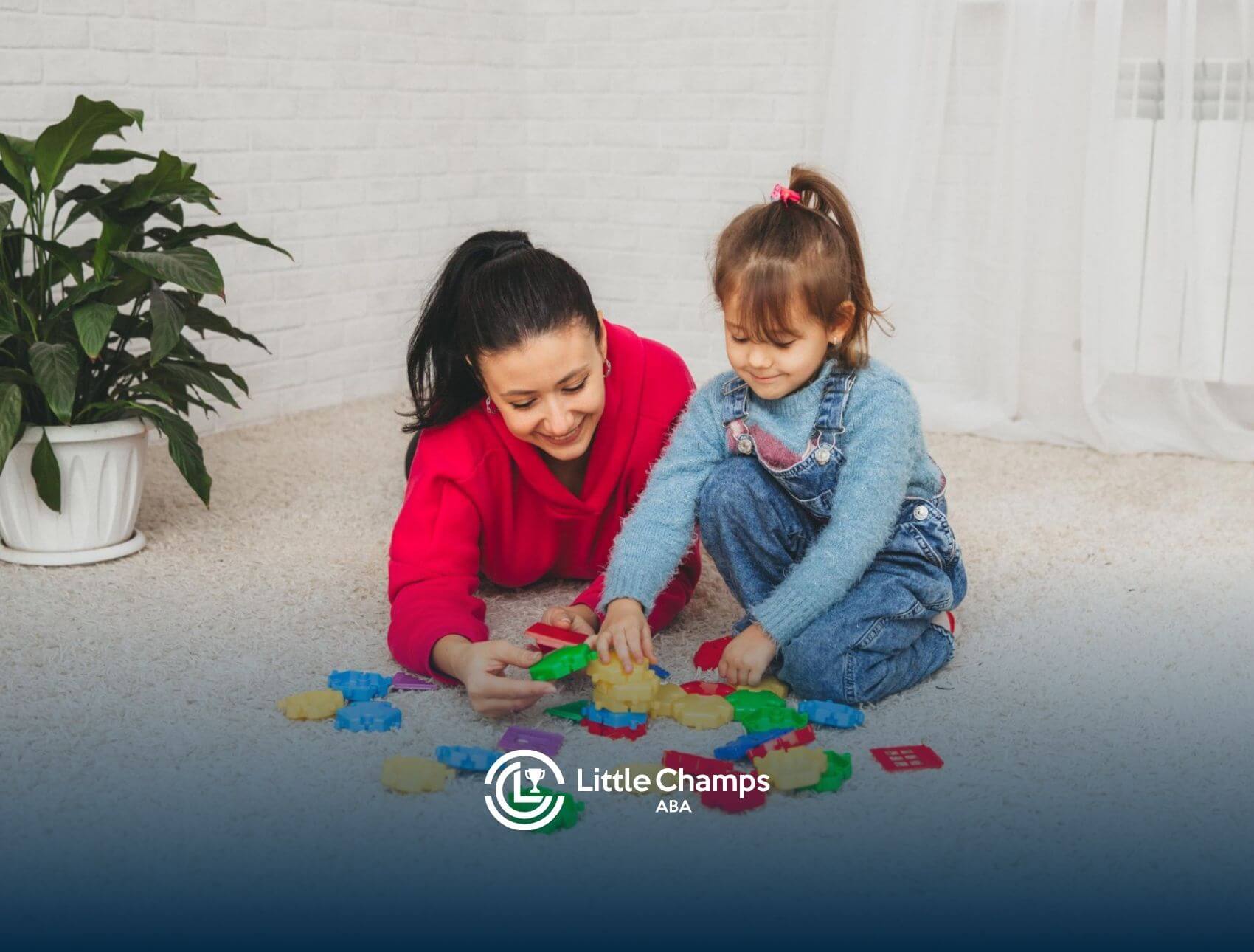 A BCBA and an autistic girl playing with colorful plastic gears on a carpeted floor in ABA therapy.