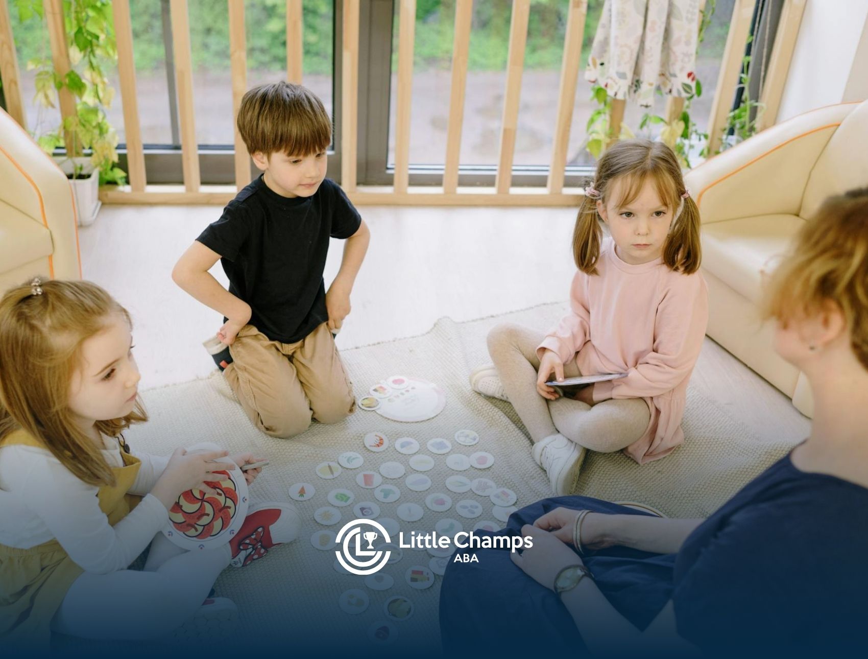 Autistic kids playing educational matching game on the floor with an ABA therapist at home in CO.
