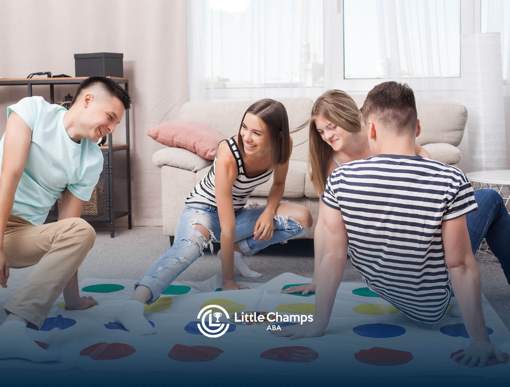 Four teenagers playing Twister and smiling in a cozy living room.