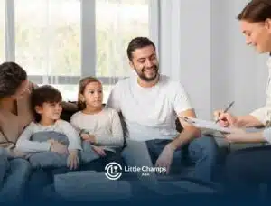 Family meeting with behavioral therapist, part of parent training in ABA therapy.