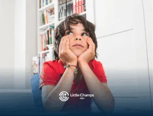 A child with autism is looking up while sitting at a table
