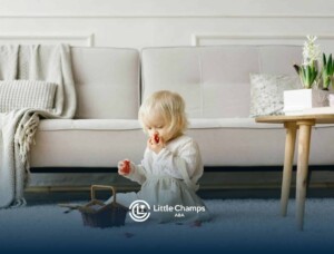 An autistic toddler sitting on a carpet, playing with red toys during in-home ABA therapy in CO.