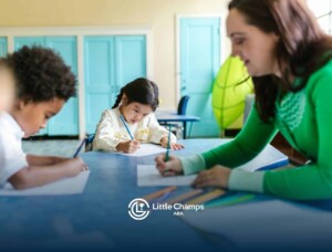 Autistic children and an RBT doing writing activity during a classroom ABA therapy session in CO.