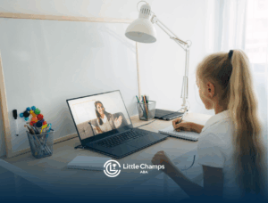 A girl with autism sitting in front of a laptop during telehealth ABA