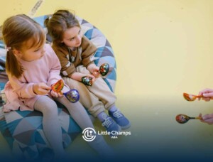 Autistic girls sitting on a beanbag, holding maracas in a music activity during ABA therapy in CO.