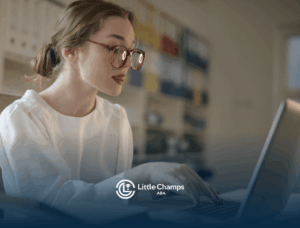 A BCBA student with red glasses studying on a laptop for BCBA exam in a study room with shelves and folders behind.