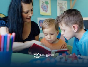 ABA therapist reading to two boys at a table in ABA therapy.