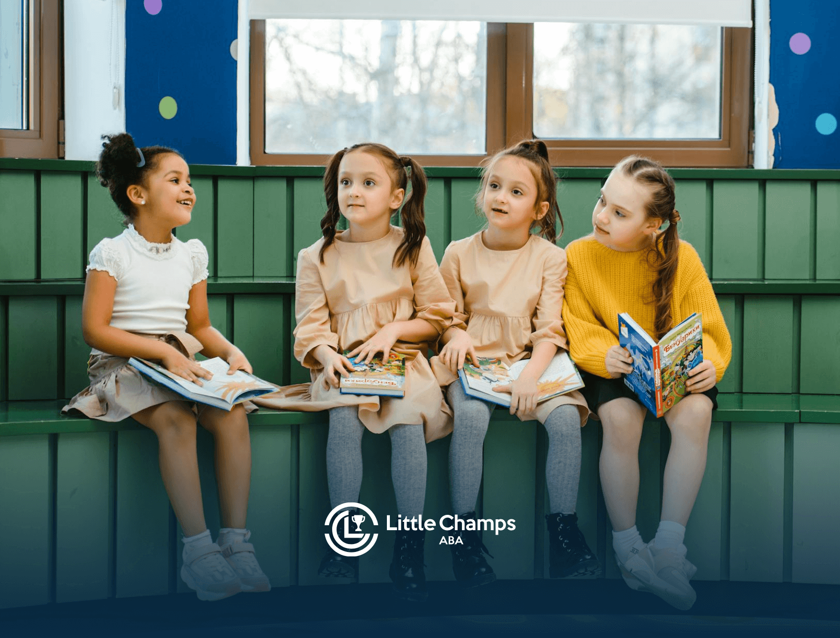 Four autistic girls sitting on a bench reading books and chatting in a colorful room during ABA therapy in UT.