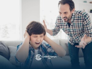 Man yelling at boy autistic covering his ears.