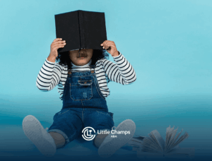 An autistic child avoiding eye contact with a book during school-based ABA therapy conversation in Utah.