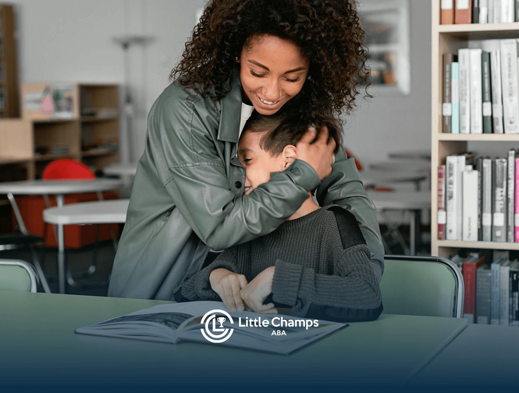 An ABA therapist hugging her autistic child while they sit at a table, looking at a book in a library in Colorado.