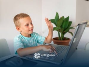 Child raising hand during online ABA therapy session.