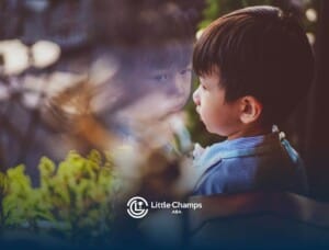 Young boy with severe autism looking at his reflection in a window.