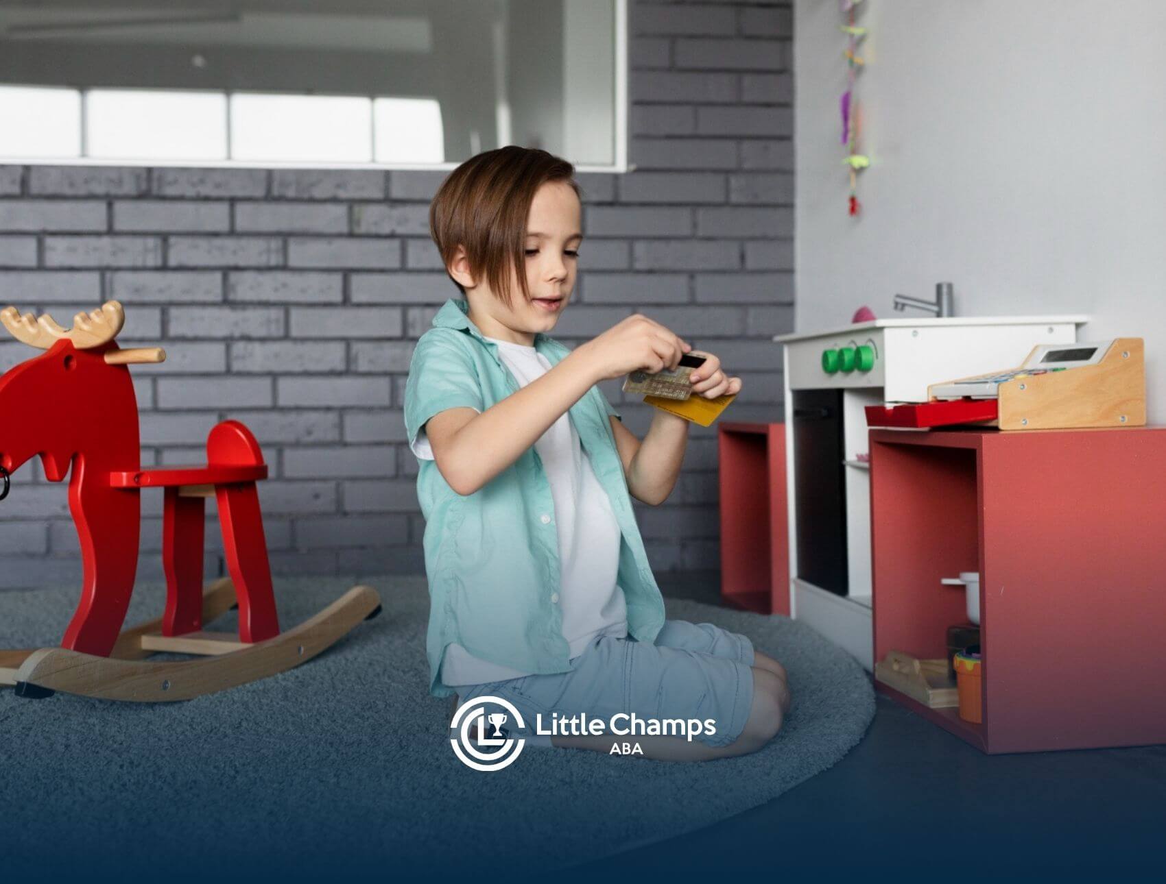 A boy with autism playing with toy kitchen set and red rocking horse.