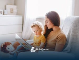 ABA therapist reading a picture book to young child with autism during ABA therapy.