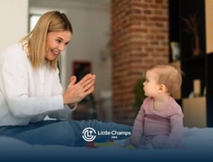 BCBA clapping hands while baby with autism watches.