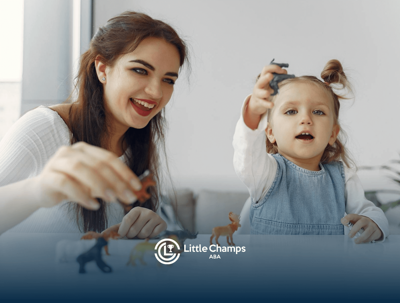 An ABA therapist and autistic child playing with animal figurines at a table during ABA therapy session in Utah.