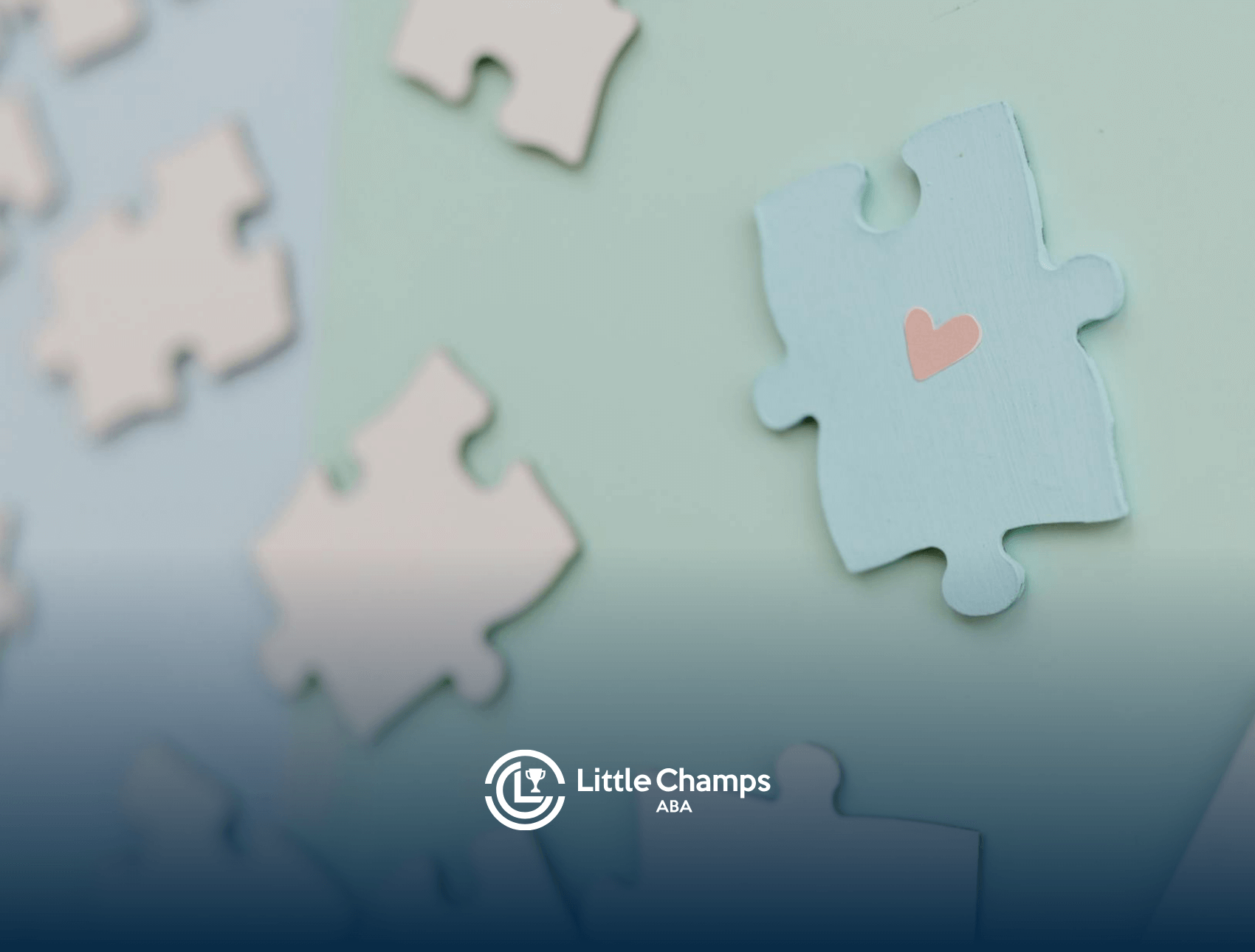 Puzzle pieces with one blue piece featuring a pink heart, symbolizing autism acceptance in Colorado.