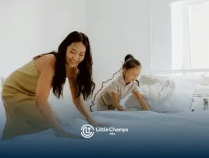 An ABA therapist and autistic girl using discrete trial teaching technique and making the bed together in UT.