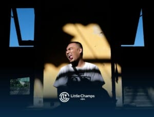 Autistic man sitting in sunlight against a yellow wall, shouting or expressing emotion in Colorado after ABA therapy.