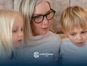 ABA therapist reading with two autistic children sitting closely beside her while looking down.