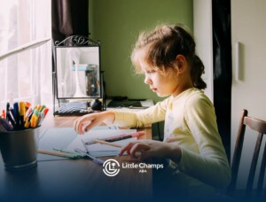 Girl with autism concentrating at a table while organizing colored pencils and drawing materials.