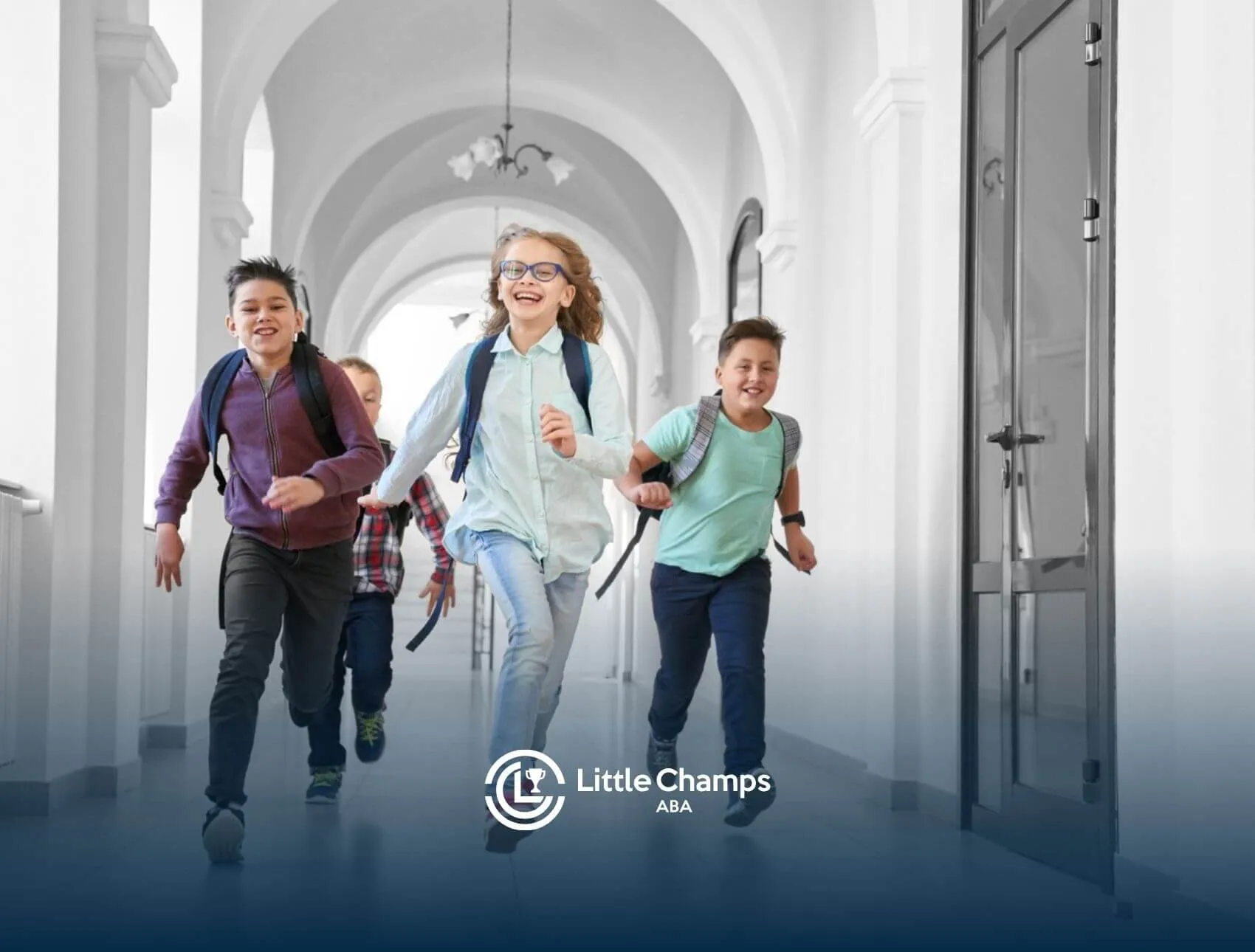 Group of school-age children with autism running down a bright hallway with backpacks.