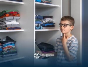 Boy choosing clothes from a neatly organized closet